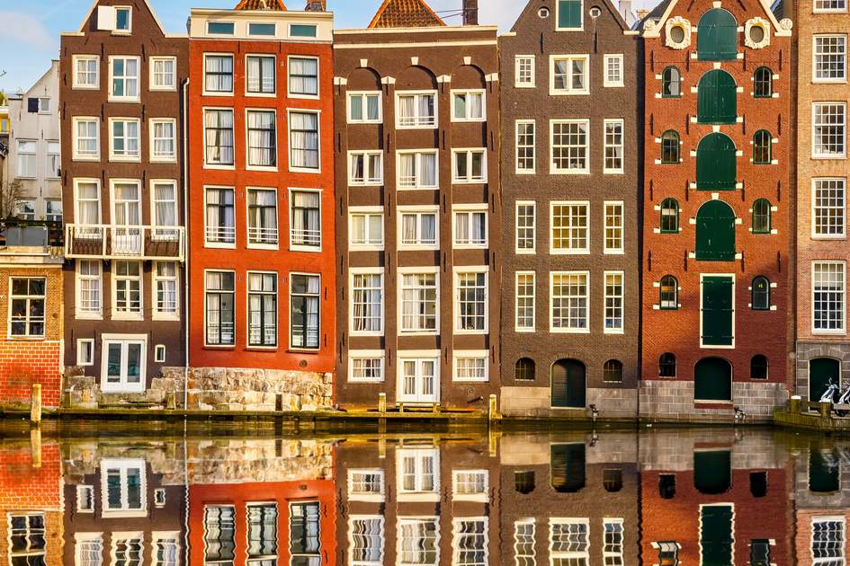 Traditional dutch buildings on canal in Amsterdam