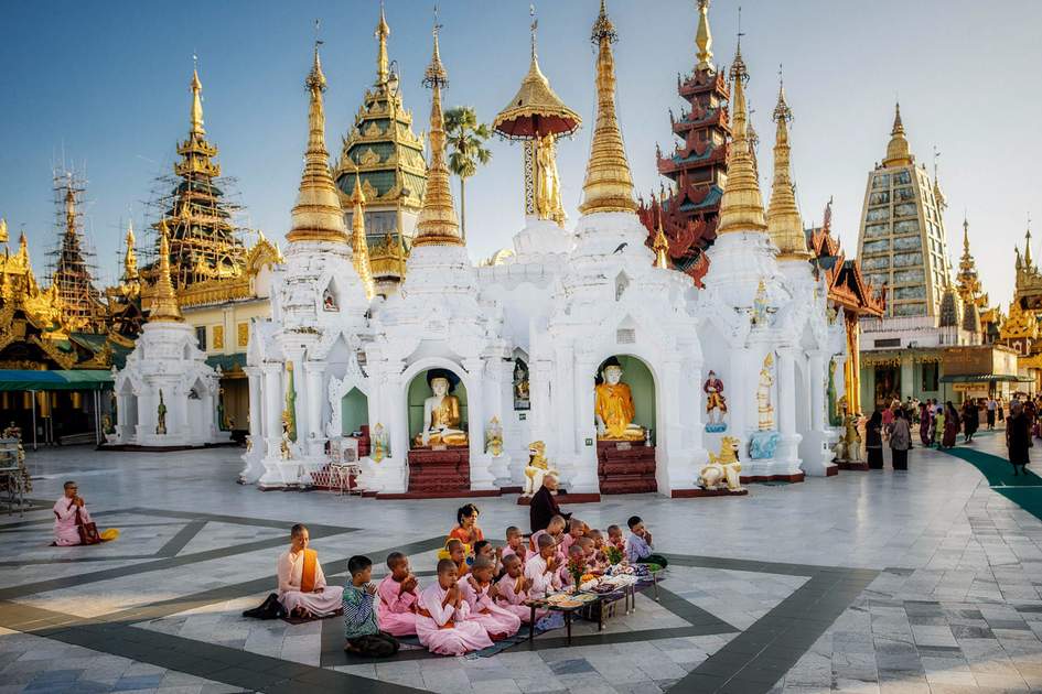 monks posing in Swedagon Pagoda on March 29, 2015 in Yangoon