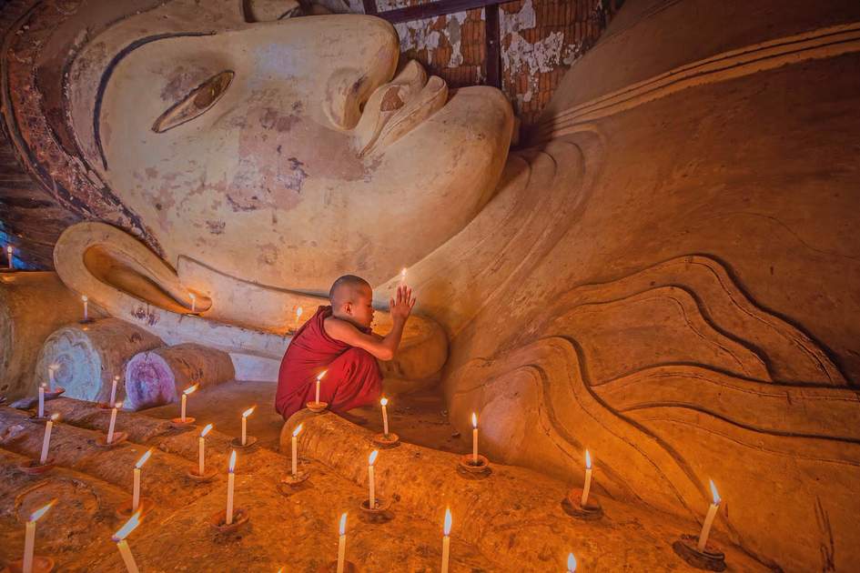 Young Buddhist monk praying at Shwesandaw Temple, Bagan, Myanmar 