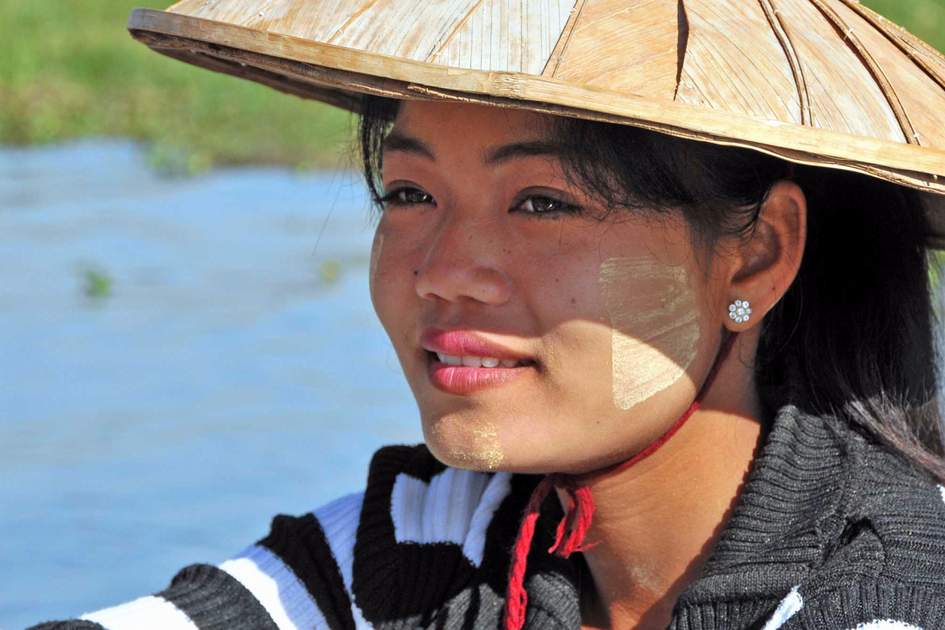 Unidentified girl demonstrates the use of Thanaka, a yellowish-white paste made from ground bark & used as a cosmetic and for sunburn protection in Bagan Myanmar