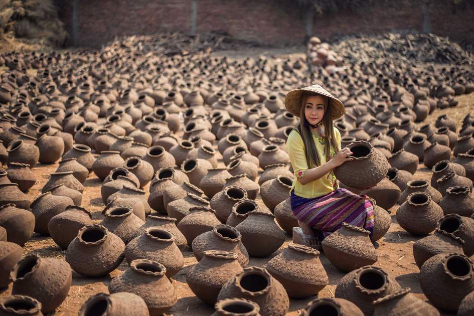 Worker Women, Happy asian traditional harvest at Mandalay Myanmar, carrying pots in Myanmar traditional costume