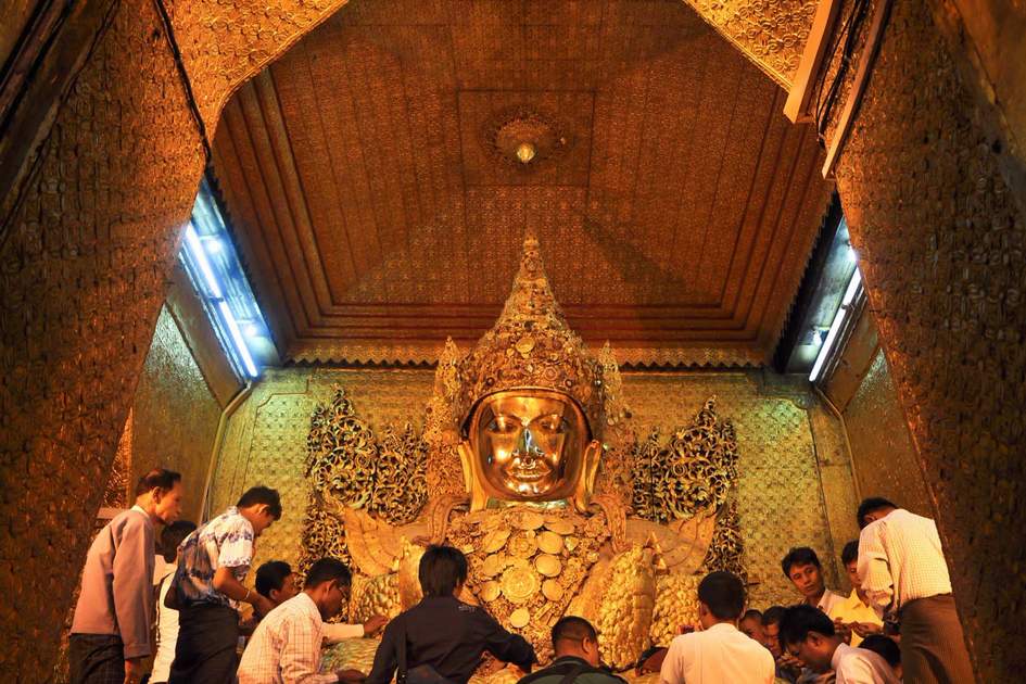  The Myanmar people pay respect to Mahamuni Buddha statue with the golden paper at Mahamuni Buddha temple.