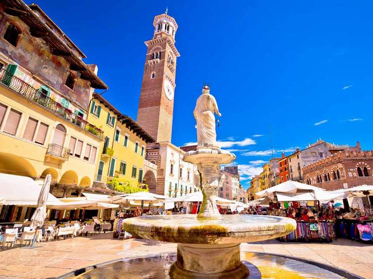 Piazza delle erbe in Verona street and market view with Lamberti tower